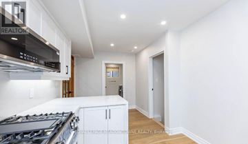 Milton (Tm Timberlea) apartment for rent - A modern kitchen with a stove top oven and a microwave.