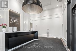 Toronto (Thorncliffe Park) condo for rent - A reception area with a black reception desk and a sign that says "UeV".
