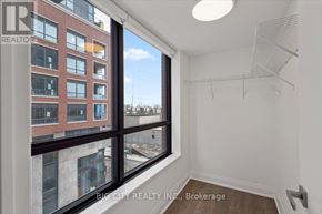 Toronto (Thorncliffe Park) condo for rent - A room with a large window overlooking a cityscape.