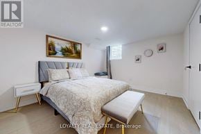 Toronto (Downsview-Roding-Cfb) townhouse for rent - A bedroom with a bed, nightstand, and a painting on the wall.