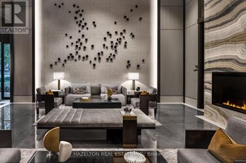 Toronto (Forest Hill South) condo for rent - A modern living room with a fireplace and a large painting on the wall.