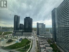 Toronto (Bayview Village) condo for rent - A cityscape with a mix of modern and older buildings, with a cloudy sky overhead.