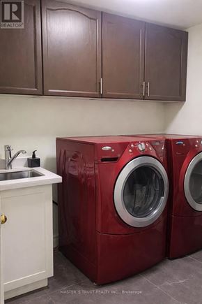 Toronto (Pleasant View) apartment for rent - Two red front load washing machines in a laundry room.