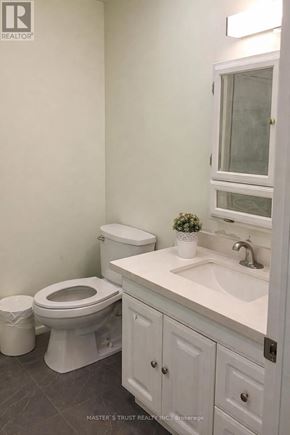 Toronto (Pleasant View) apartment for rent - A white toilet sits next to a white sink in a bathroom.