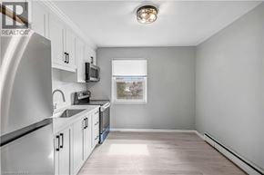Kitchener apartment for rent - A kitchen with white cabinets and a stainless steel refrigerator.