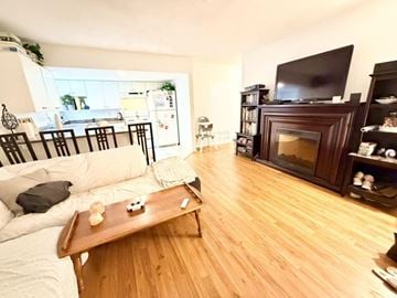 Surrey apartment for rent - A living room with a white couch and a wooden coffee table.