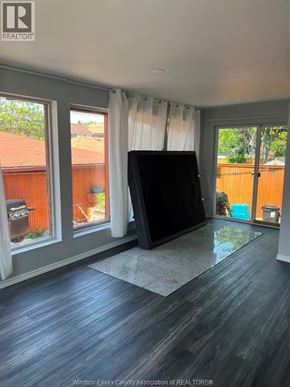 Windsor apartment for rent - A room with a large window and a flat screen TV.