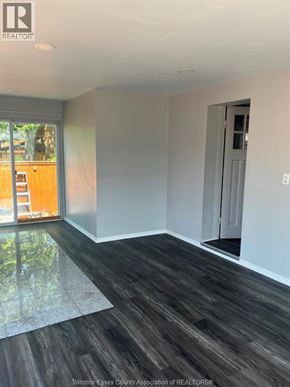 Windsor apartment for rent - A room with wooden flooring and a glass door leading outside.