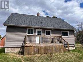 Richards Landing apartment for rent - A house with a grey roof and a wooden deck.