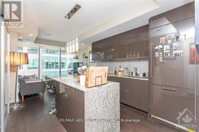 Ottawa condo for rent - A modern kitchen with a large island and stainless steel appliances.