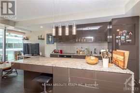 Ottawa condo for rent - A modern kitchen with a large island and stainless steel appliances.