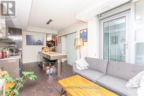 Ottawa condo for rent - A living room with a grey couch and a wooden coffee table.