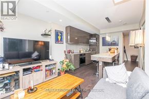 Ottawa condo for rent - A living room with a grey couch and a wooden coffee table.