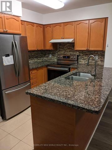 Toronto (Willowdale East) condo for rent - A kitchen with a granite counter top and wooden cabinets.