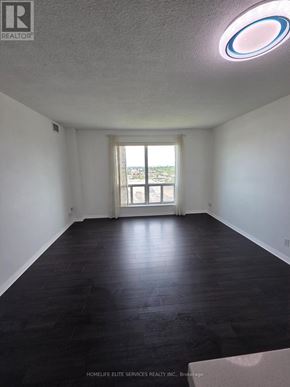 Toronto (Woburn) condo for rent - A room with a window and a wooden floor.