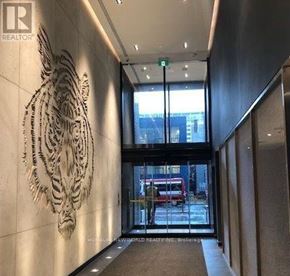 Toronto (Church-Yonge Corridor) condo for rent - A tiger head sculpture is on the wall of a building.