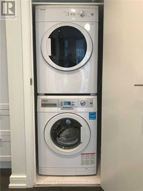 Toronto (Church-Yonge Corridor) condo for rent - A white front loading washing machine with a blue label on the door.