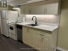 Toronto (Danforth) apartment for rent - A kitchen with a white refrigerator, white stove, and white countertops.