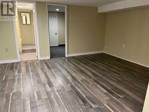 Toronto (Danforth) apartment for rent - A room with wooden flooring and beige walls.