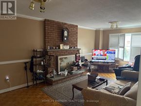 Vaughan (East Woodbridge) apartment for rent - A living room with a fireplace and a television playing a cartoon.