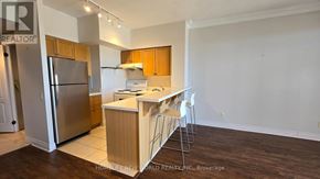 Toronto (Willowdale East) condo for rent - A kitchen with a refrigerator, stove, and island.