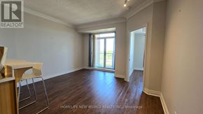 Toronto (Willowdale East) condo for rent - A room with wooden floors and a sliding glass door leading to a balcony.