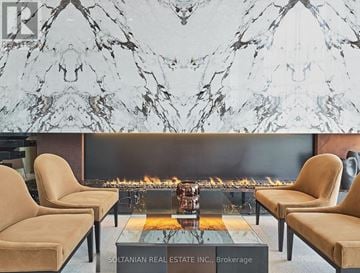 Toronto (Bayview Village) condo for rent - A living room with a fireplace and chairs.