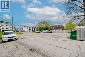 Waterloo apartment for rent - A white car is parked in a parking lot with a REALTOR® sign in the upper left corner.