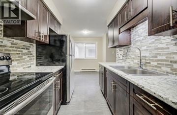Waterloo apartment for rent - A kitchen with dark wood cabinets and a marble countertop.
