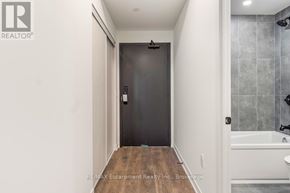 Burlington (Alton) house for rent - A bathroom with a black door and a white tub.