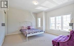Niagara Falls (Oldfield) apartment for rent - A bedroom with a white bed and a purple chair.