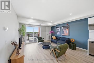Welland (Lincoln/Crowland) multi-family for rent - A living room with a green chair and a blue couch.