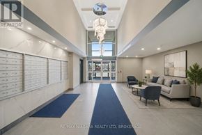 Welland (Lincoln/Crowland) multi-family for rent - A spacious lobby with a blue carpet and a glass ceiling light fixture.