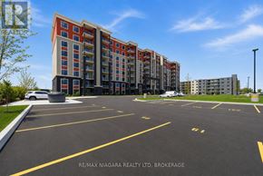 Welland (Lincoln/Crowland) multi-family for rent - A parking lot in front of a multi-story residential building.