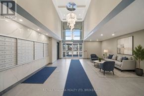 Welland (Lincoln/Crowland) multi-family for rent - A spacious hallway with blue carpeting and a glass ceiling light fixture.