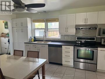 Oshawa (Lakeview) apartment for rent - A kitchen with a table and chairs in front of it.