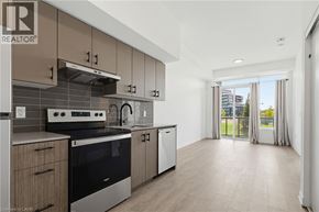 Burlington condo for rent - A modern kitchen with a stove top oven and a dishwasher.