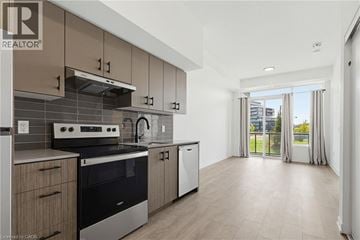Burlington condo for rent - A modern kitchen with a stove top oven and a dishwasher.