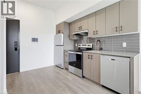 Burlington condo for rent - A modern kitchen with wooden cabinets and stainless steel appliances.