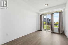 Burlington condo for rent - A room with a sliding glass door leading to a balcony.