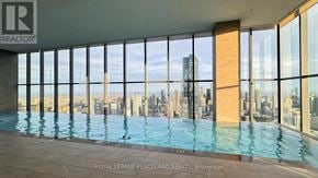 Toronto (Bay Street Corridor) condo for rent - A swimming pool with a view of the city skyline.
