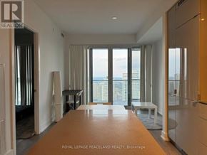 Toronto (Bay Street Corridor) condo for rent - A spacious room with a view of the city through large windows.