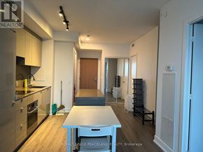 Toronto (Bay Street Corridor) condo for rent - A kitchen with a table in the middle of the room.