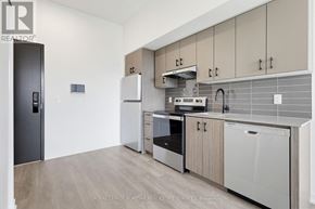 Burlington (Alton) condo for rent - A modern kitchen with wooden cabinets and stainless steel appliances.