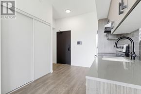 Burlington (Alton) condo for rent - A modern kitchen with a sink and a black door.