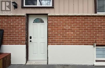 Pickering (West Shore) apartment for rent - A white door with a glass window is set in a brick wall.