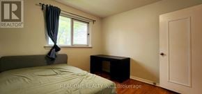 Toronto (Woburn) apartment for rent - A bedroom with a bed, window, and a door.