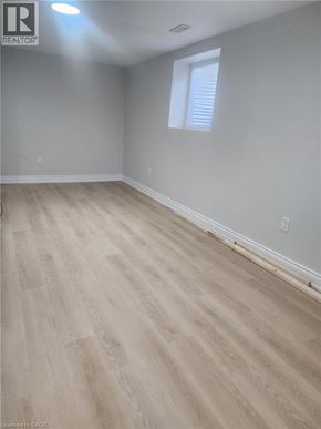 Kitchener apartment for rent - A room with wooden flooring and a window with blinds.
