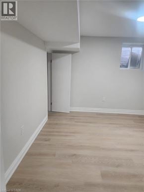 Kitchener apartment for rent - A room with a white wall and a wooden floor.