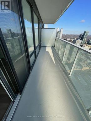 Toronto (Church-Yonge Corridor) condo for rent - A balcony with glass railings overlooking a cityscape.